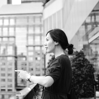 Young woman on balcony with tablet